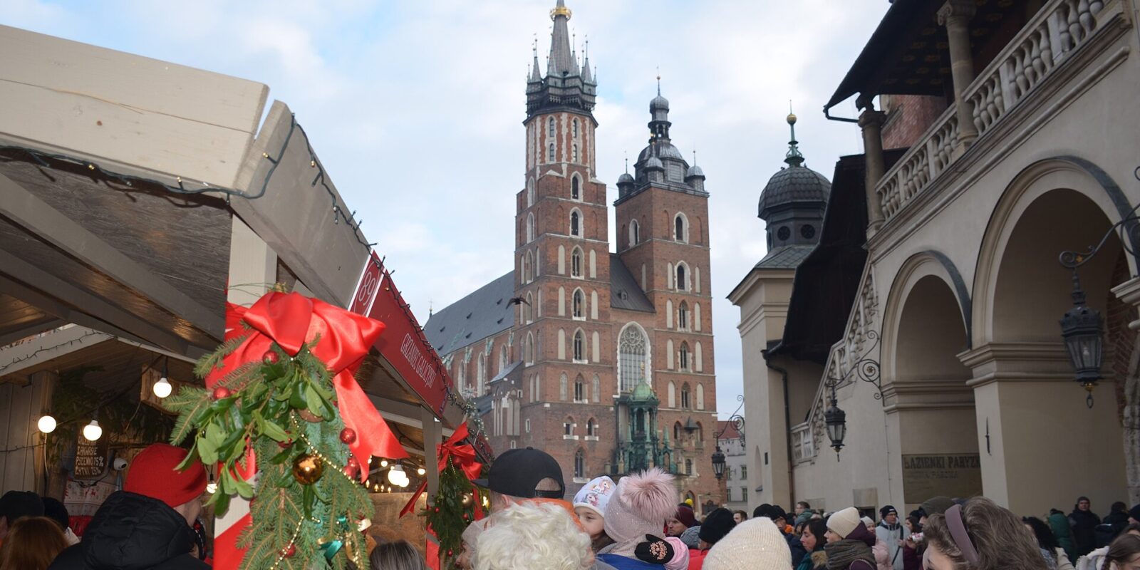 Crowds at the Christmas market on Kraków's Main Square, with St Mary's Basilica behind