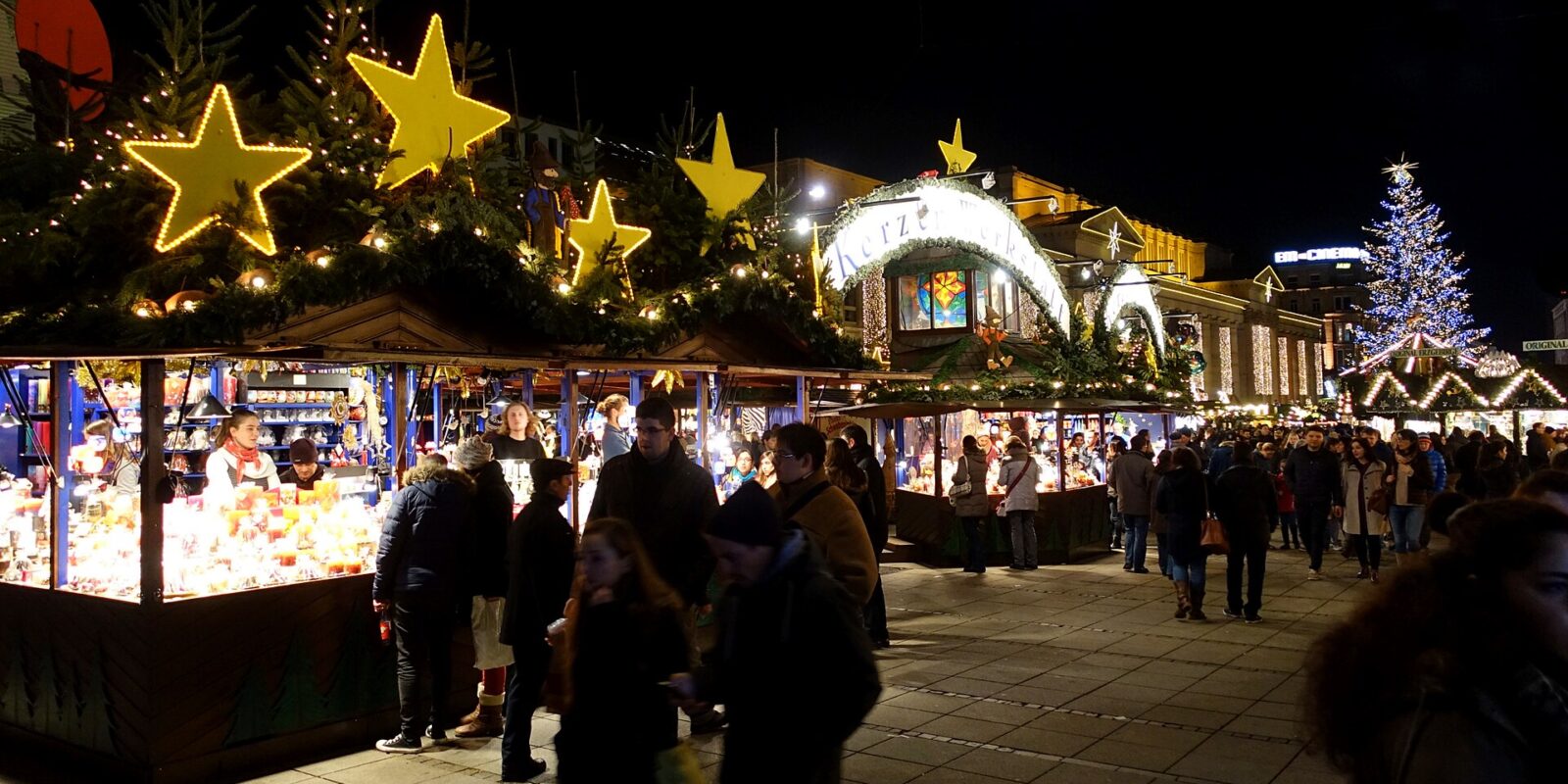 Stalls with illuminated stars on their roofs at the Stuttgart Christmas market