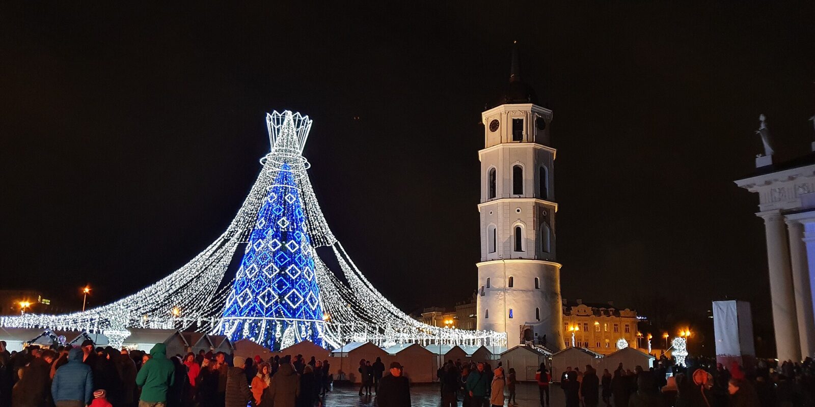 The illuminated Christmas tree and the cathedral bell tower on Cathedral Square in Vilnius