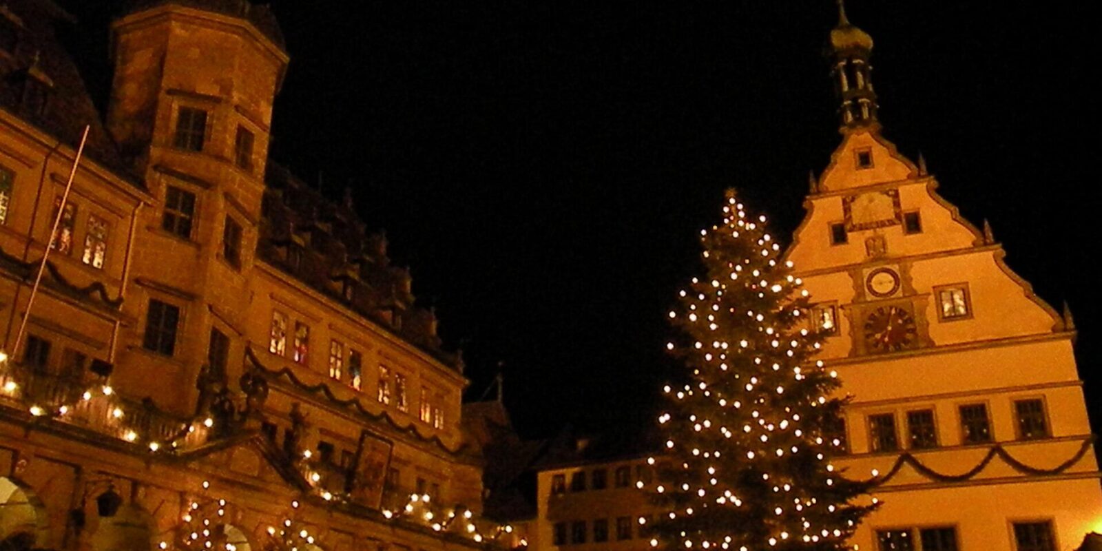 The Christmas tree and illuminated gabled buildings on the Marktplatz in Rothenburg ob der Tauber at night